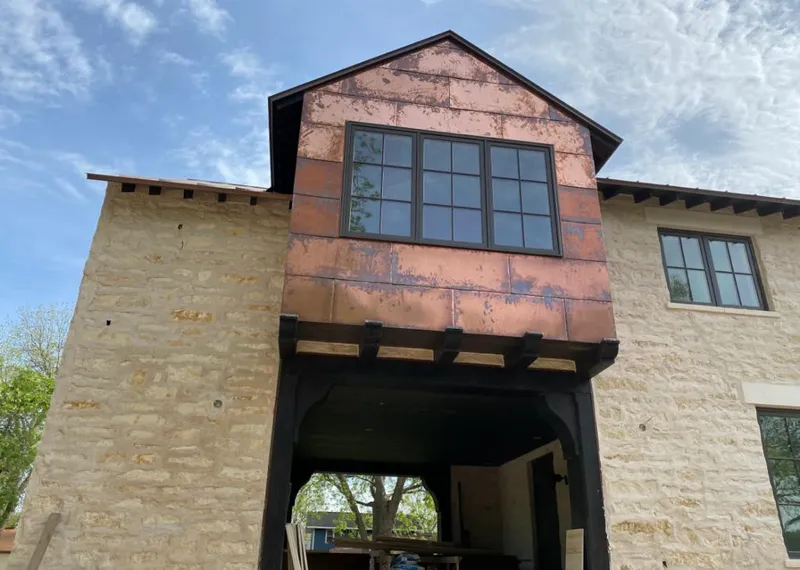Copper metal panel facade on a stone building for Skylight Installation in Wailuku